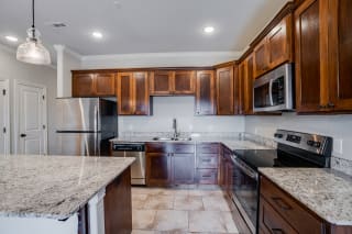 Kitchen Featuring Tile-Style Flooring With Lots Of Cabinetry