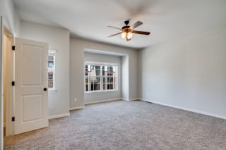 Carpeted Bedroom With Large Windows  Including Window Treatments