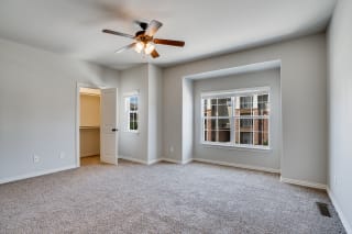 Carpeted Bedroom With Spacious Closet & Ceiling Fan