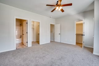 Carpeted Bedroom With Attached Bathroom & Two Walk-In Closets