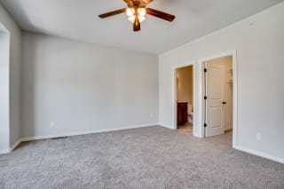 Carpeted Bedroom With Tall Ceilings