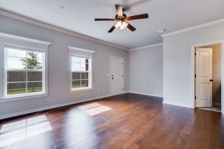 Large Living Room With Wood-Style Flooring and Large Windows