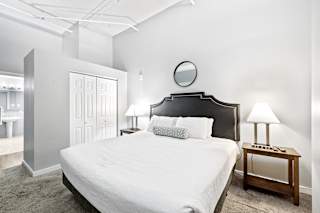 a bedroom with a bed and two nightstands
