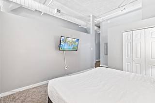 a bedroom with a bed and a tv