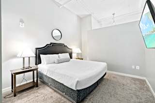 a bedroom with a bed and two nightstands