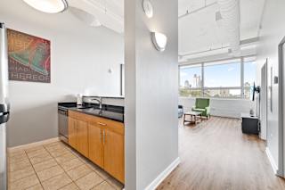 a kitchen with wooden cabinets and a large window