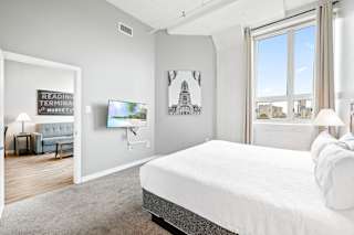 a bedroom with a bed and a tv