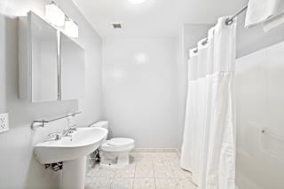 a bathroom with a toilet sink and shower