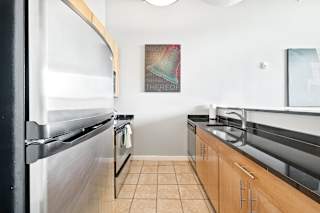 a kitchen with stainless steel appliances and white walls