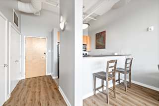 a kitchen and dining area in a 555 waverly unit