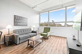 a living room with a couch chair coffee table and a large window