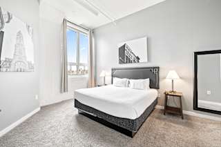 a bedroom with a large bed and a window