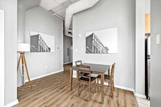 a dining room with a wooden table and chairs