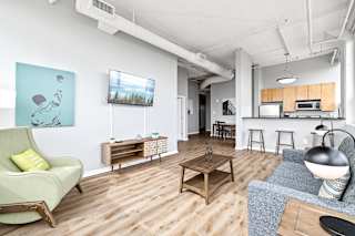 a living room with white walls and hardwood floors