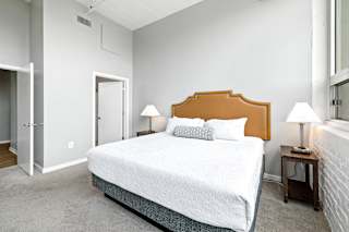a bedroom with a bed and two nightstands