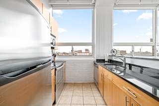 a kitchen with a large window and a view of the city