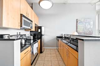 a kitchen with wooden cabinets and black appliances