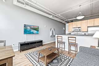 a living room with a coffee table and two chairs