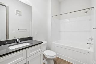 A white bathroom with a sink, toilet, and bathtub.