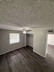 A room with a ceiling fan and a window.