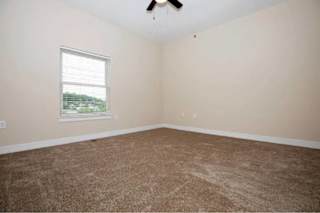 A room with a carpet floor and a window.