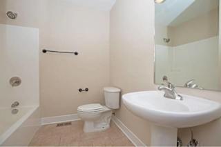 A white toilet sits next to a sink in a bathroom.