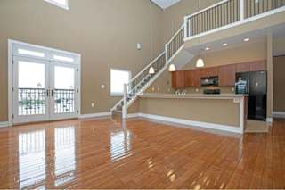 A spacious living room with a staircase leading to the upper floor.