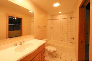 A bathroom with a toilet, sink, and bathtub.