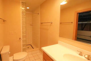 A bathroom with a toilet, sink, and shower.