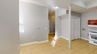 A kitchen with a white oven and a white wall.