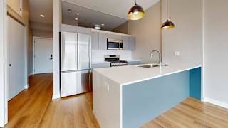 A kitchen with a white counter and a blue accent wall.