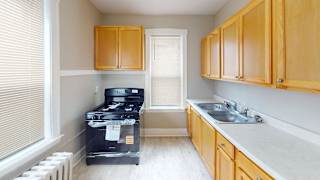 A kitchen with wooden cabinets and a black stove top oven.