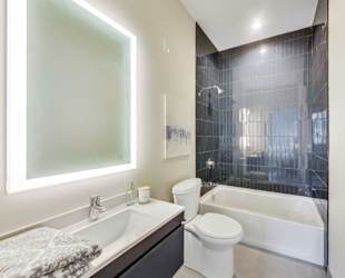 a bathroom with a toilet and a tub and a sink