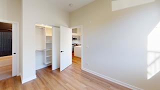 a renovated living room with white walls and wood floors