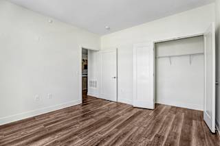 Empty bedroom with closet and wood flooring at Inwood at Renaissance Square Apartments, Marlton
