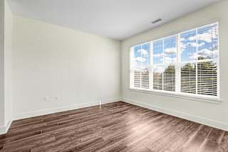 Empty bedroom with large windows and wood flooring at Inwood at Renaissance Square Apartments, New Jersey