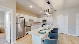 A kitchen with a table set for a meal at The Slate, Jeffersonville, 47130