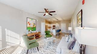 A living room with a green chair and a white couch at The Slate, Jeffersonville, 47130