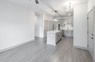 A kitchen with white cabinets and a white island at Arbour Place Apartments, Jeffersonville, IN