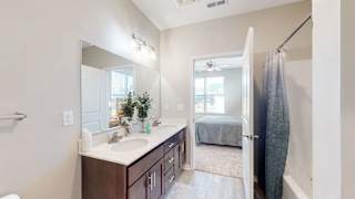 A bathroom with a white sink and a mirror at The Slate, Jeffersonville, 47130