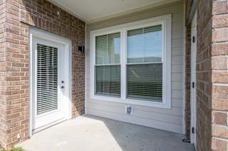 A white door and window on a house at Arbour Place Apartments, Jeffersonville, IN