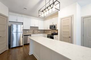 Modern kitchen with white cabinets at Allure Apartments, Whiteland, IN 46184