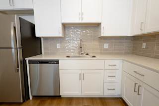 Modern kitchen with white cabinets and stainless appliances at Allure Apartments, Whiteland, IN 46184