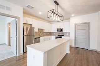 Bright kitchen with large island and pendant lighting at Allure Apartments, Whiteland, Indiana