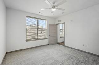 Spacious carpeted bedroom with ceiling fan and natural light at Allure Apartments, Whiteland, 46184