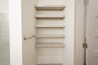 Floating shelves with towel bar in bathroom nook at Allure Apartments, Whiteland, IN