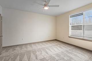 Spacious bedroom with light carpet and large window at Allure Apartments, Indiana, 46184