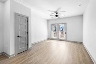 A room with a ceiling fan and a sliding glass door. at Arbour Place Apartments, Indiana