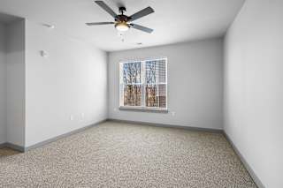 A room with a ceiling fan and a window with blinds at Arbour Place Apartments, Jeffersonville, IN
