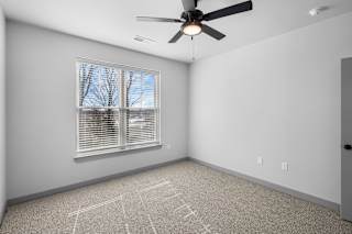 A room with a ceiling fan and a window with blinds at Arbour Place Apartments, Jeffersonville, IN, 47130